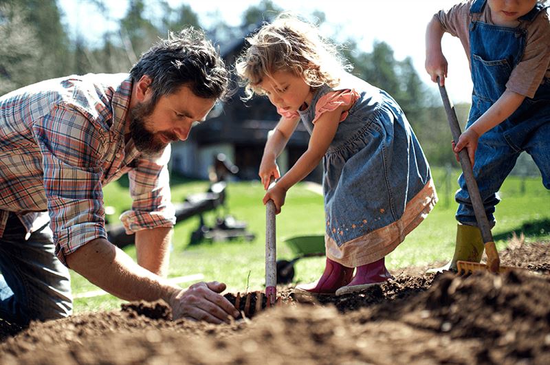 kaw valley greenhouse ecological gardening family working in garden.png